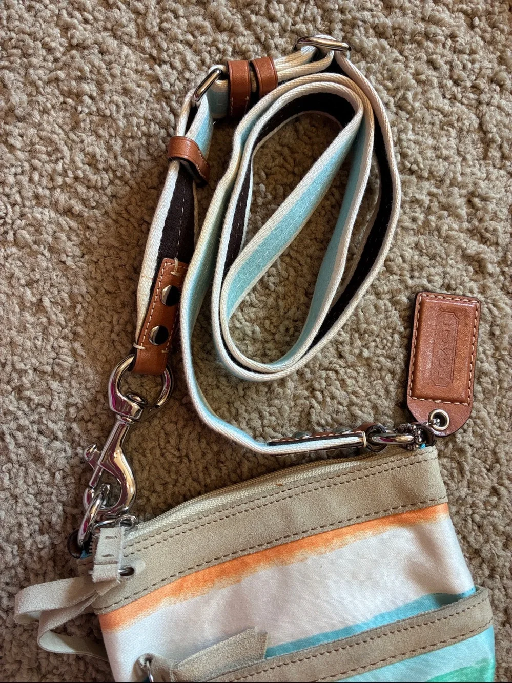 Coach Multicolor Canvas Crossbody bag with Turquoise Lining.